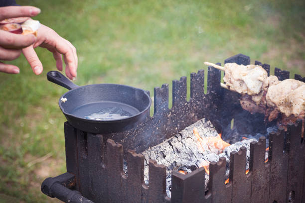 istock Hands taking a frying pan from a stove 1345448440