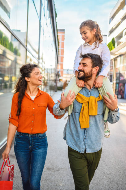 istock Young cheerful family in shopping. 1345448627