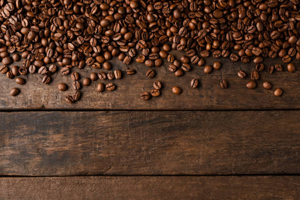 istock Coffee beans on wooden background with copyspace. 1345449496