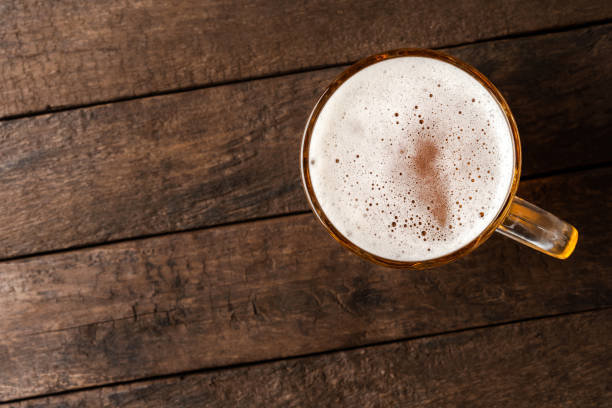 istock Beer glass on an old wooden table. Top view 1345450280
