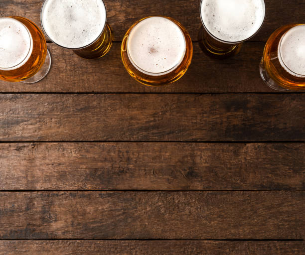 istock Beer glasses on wooden table with copyspace. 1345450290