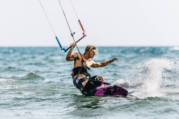 istock Young man enjoying in kiteboarding during summer day at sea. 1345452025