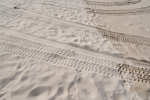 4x4 tyre tracks crisscrossing Tire tracks on the sand texture background.