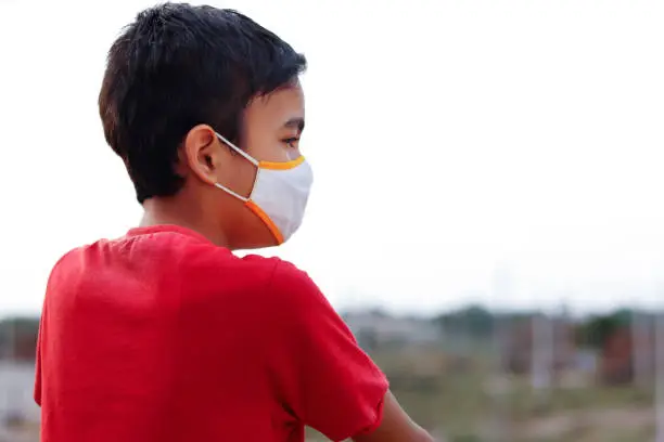 Little Indian cute boy wearing mask during corona virus and flu outbreak. Mask for corona virus prevention.