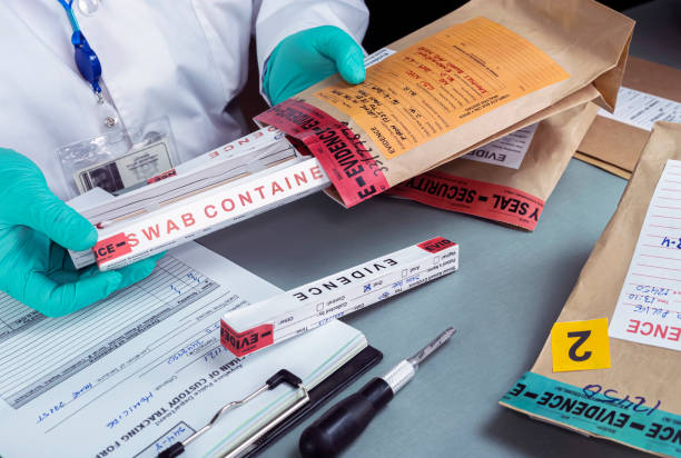 istock Forensic police check files against evidence in crime lab, conceptual image 1345454663
