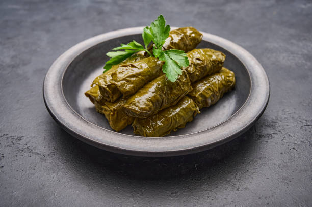 istock Traditional Middle Eastern dish dolma or tolma, with parsley in black plate 1345454853