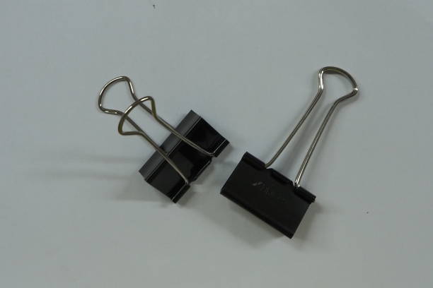 istock Black paper clip  isolated on white background. 1345456672