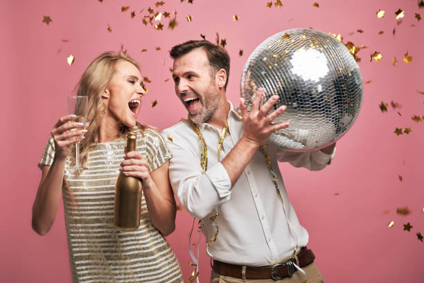 istock Shouting couple dancing and drinking champagne 1345456919