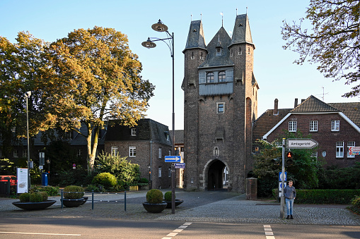 Kempen, Germany, October 4, 2021- Of the four city gates that once secured access to the city of Kempen, only the gate tower of the Kuhtor is still preserved, some unidentified people in the background.