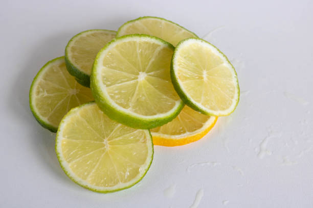 istock Lime, lemon - juicy ripe citrus pieces on a white background. Ingredients for making refreshing drinks and Mojito cocktails. Place for your text 1345458622