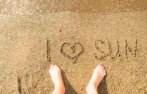 Inscription I love the sun on the sea sand - summer vacation at the sea