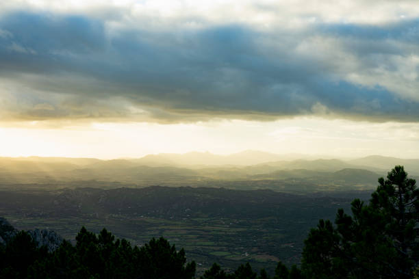 View from above, stunning view of a grasslands surrounded by a mountain range during a beautiful sunrise. Panoramic view from Monte Pino, (Vedetta Monte Pino) Sardinia, Italy.