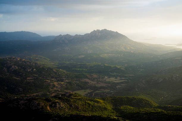 View from above, stunning view of valley surrounded by a mountain range during a beautiful sunrise. Panoramic view from Monte Pino (Vedetta Monte Pino) Sardinia, Italy.