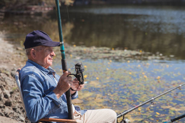 istock Serious senior man fishing 1345461414