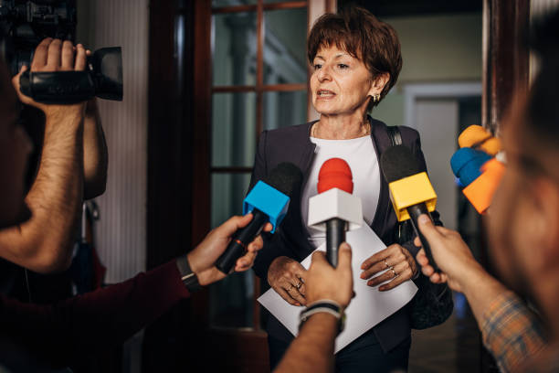 istock Female politician talking to the press 1345462193