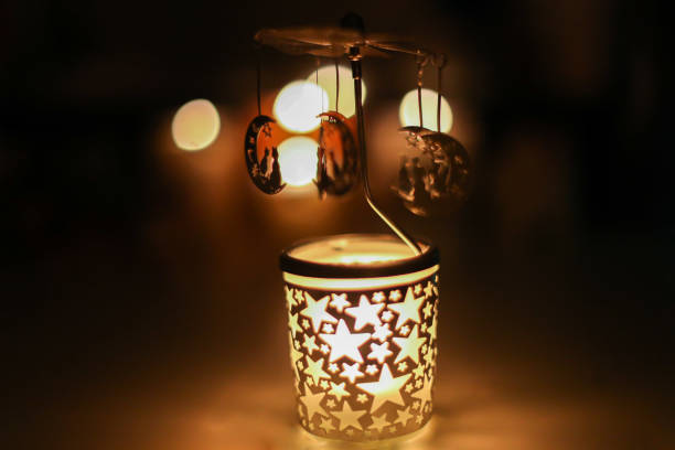istock Cats on a Rotating Go-round Carousel Candle Holder in a dark room 1345463527
