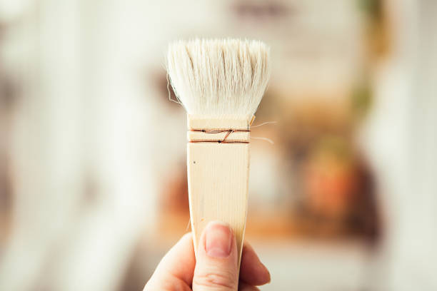 istock One big white paint brush in somebody's hand 1345463774