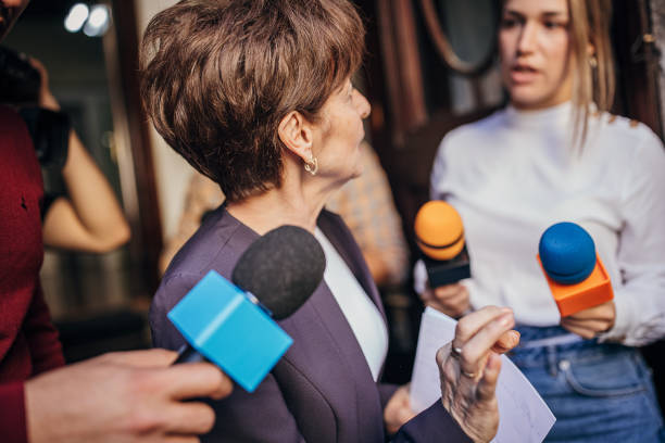 istock Female politician talking to the press 1345465665