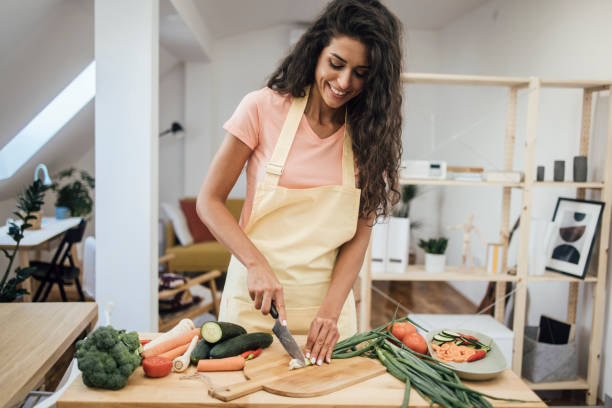 istock Portrait of a beautiful vegan making herself a lunch 1345465738