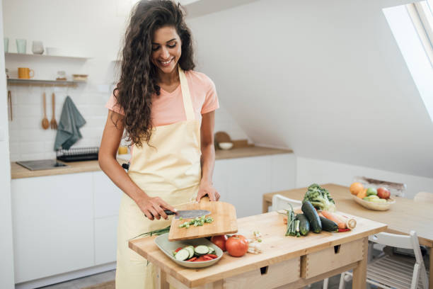 istock Beautiful vegan making a fresh meal 1345465744