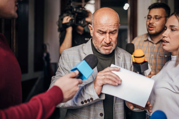 istock Male politician passing by the press 1345466740