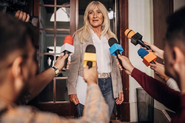 istock Female politician talking to the press 1345468189