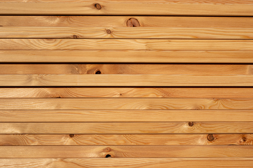 Stacks of air-dried spruce wood for the construction of the new carport