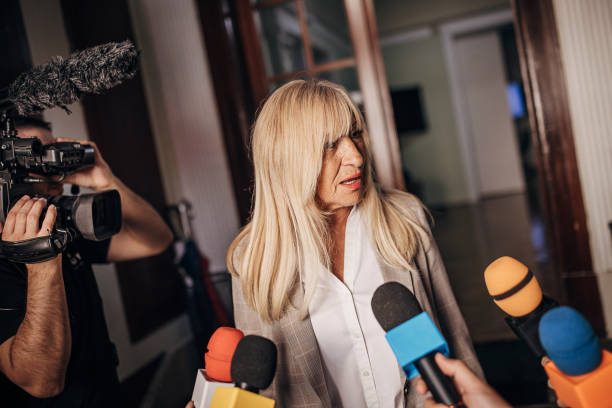 istock Female politician talking to the press 1345468329