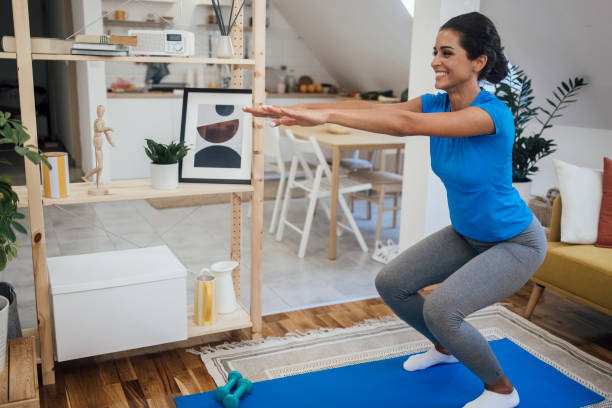 istock Young woman doing a training at her living room 1345468439