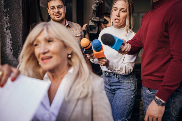 istock Female politician moving past the press 1345469150