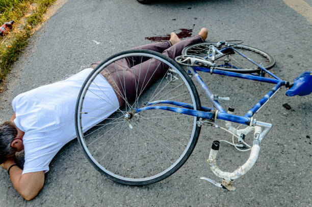 istock A Cyclist had a Terrible Accident and is Lying on a Road. 1345471040