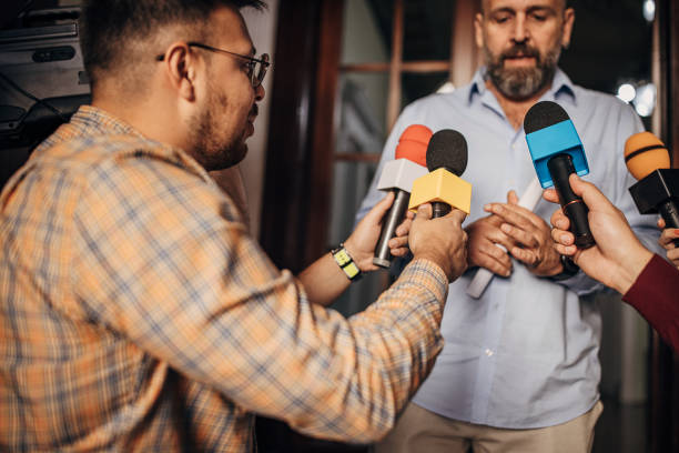 istock Male politician talking to the press 1345471973