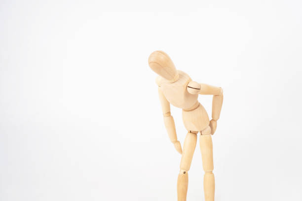 istock Wooden puppet showing back pain isolated on white background. 1345472319