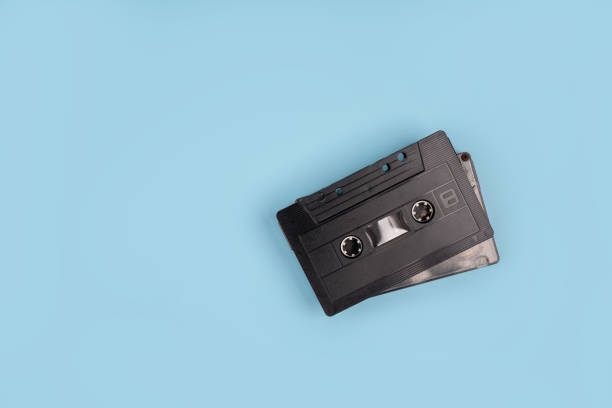 istock Old audio cassettes on turquoise background 1345472342