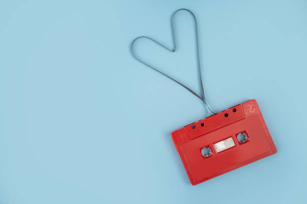 istock Red cassette tape on background 1345472351