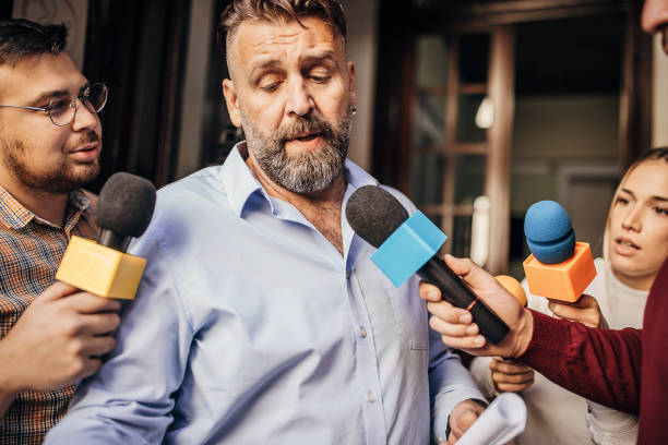 istock Male politician confronted by journalists 1345472510