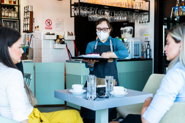 istock Young woman with Down Syndrome working at cafe 1345475781