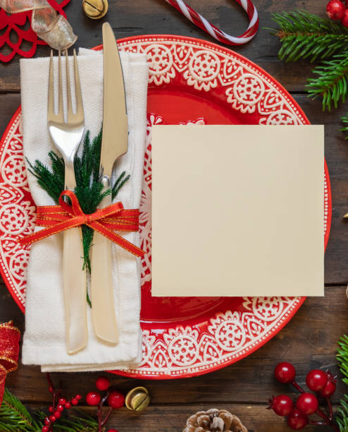 istock Festive table setting of with fir tree branches and Christmas decorations. Greeting card mockup 1345476284