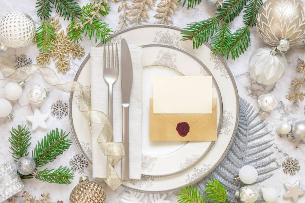 istock Festive table setting with Christmas decorations. Card and envelope mockup 1345476293