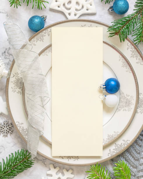 istock Festive table setting of with fir tree branches and Christmas decorations. Menu card mockup 1345476294