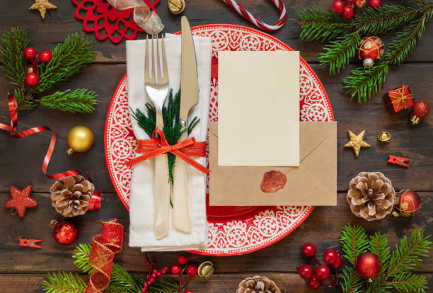 istock Festive table setting with Christmas decorations. Card and envelope mockup 1345476296