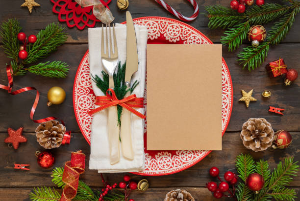 istock Festive table setting of with fir tree branches and Christmas decorations. Greeting card mockup 1345476298
