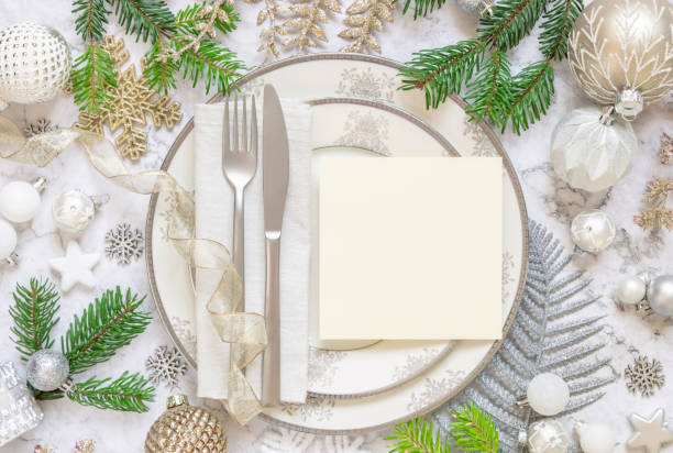 istock Festive table setting of with fir tree branches and Christmas decorations. Greeting card mockup 1345476300