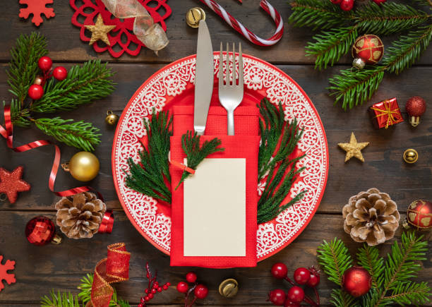 istock Festive table setting of with fir tree branches and Christmas decorations. Greeting card mockup 1345476302