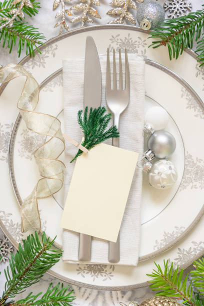 istock Festive table setting of with fir tree branches and Christmas decorations. Card mockup 1345476308