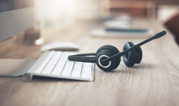 Shot of a pair of headsets lying on the desk in an empty office Someone needed a break headset stock pictures, royalty-free photos & images