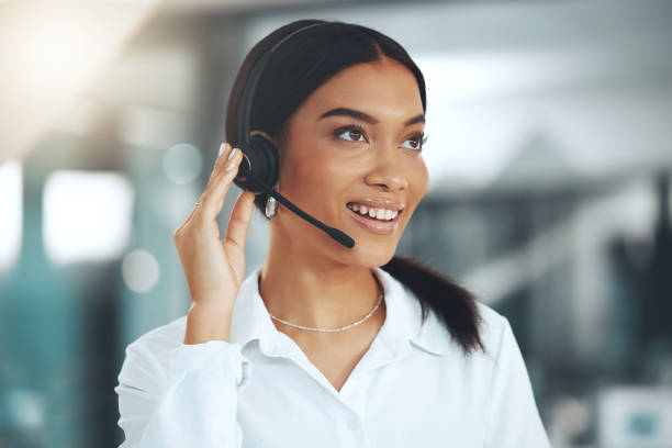 istock Shot of a young call centre agent standing alone in her office 1345477990