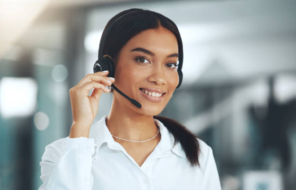 istock Shot of a young call centre agent standing alone in her office 1345477993