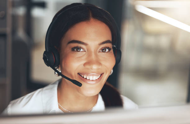 istock Shot of a young call centre agent sitting alone in her office and using her computer 1345478003