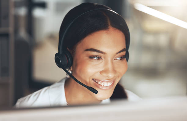 istock Shot of a young call centre agent sitting alone in her office and using her computer 1345478006